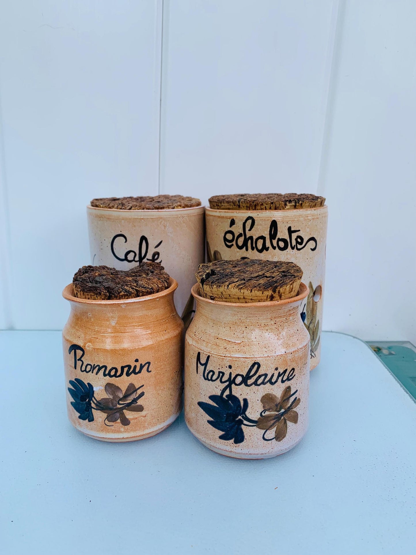 Set of 4 Pottery Canisters with Hand Painted Designs  with Cork Tops