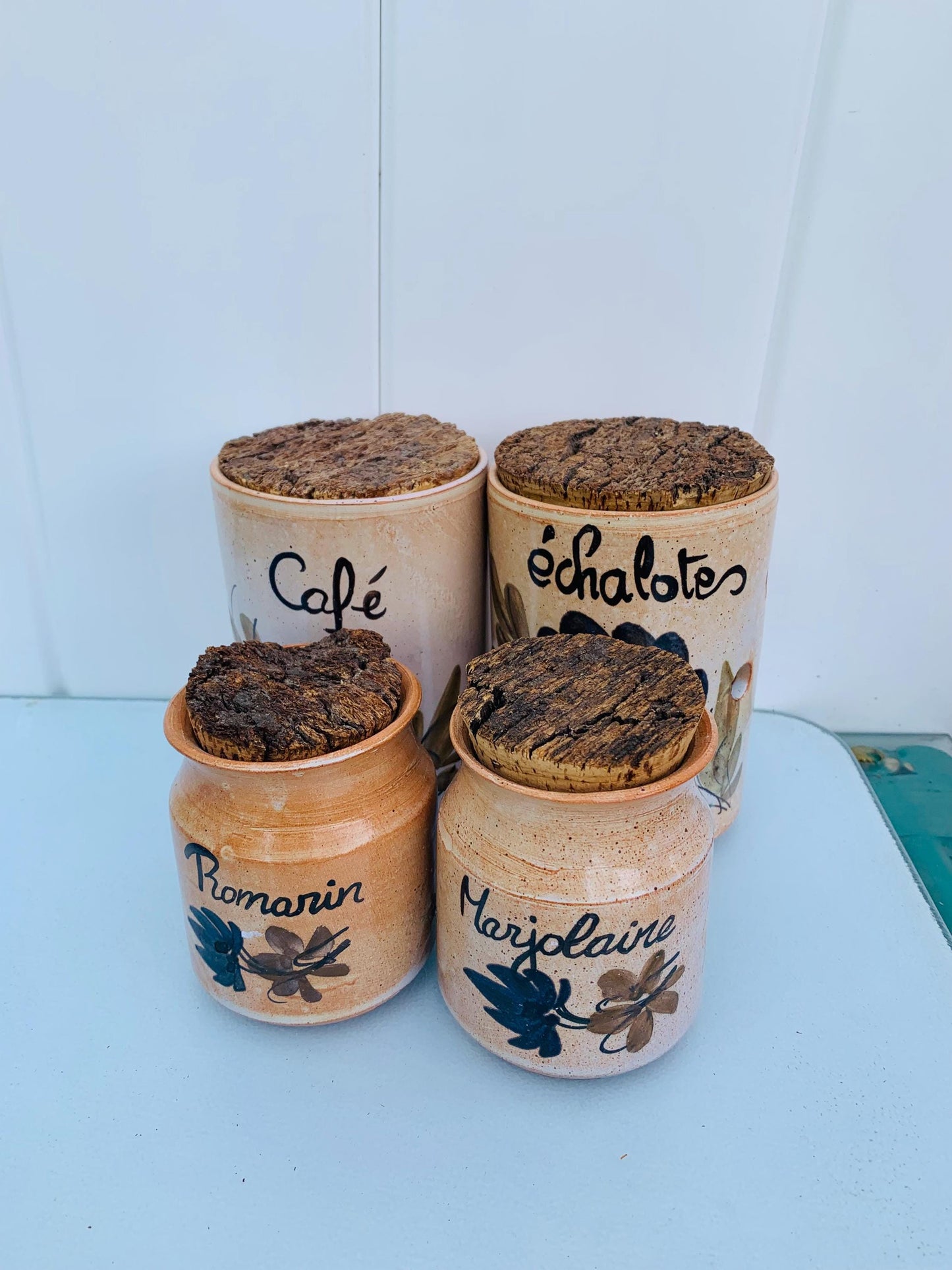 Set of 4 Pottery Canisters with Hand Painted Designs  with Cork Tops